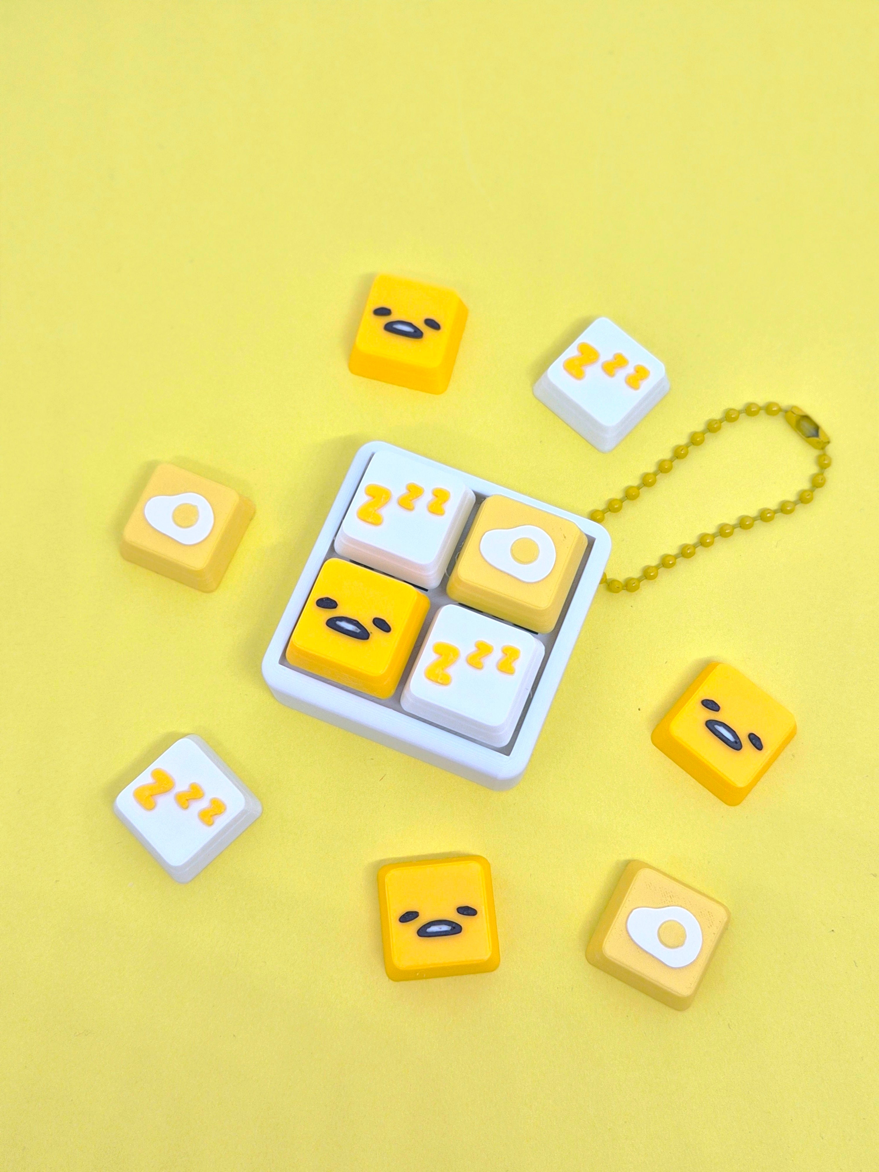 Masa Crafts Studio Gudatama fidget clicker keychain with a yellow Gudatama figure and a metal keyring for stress relief.
