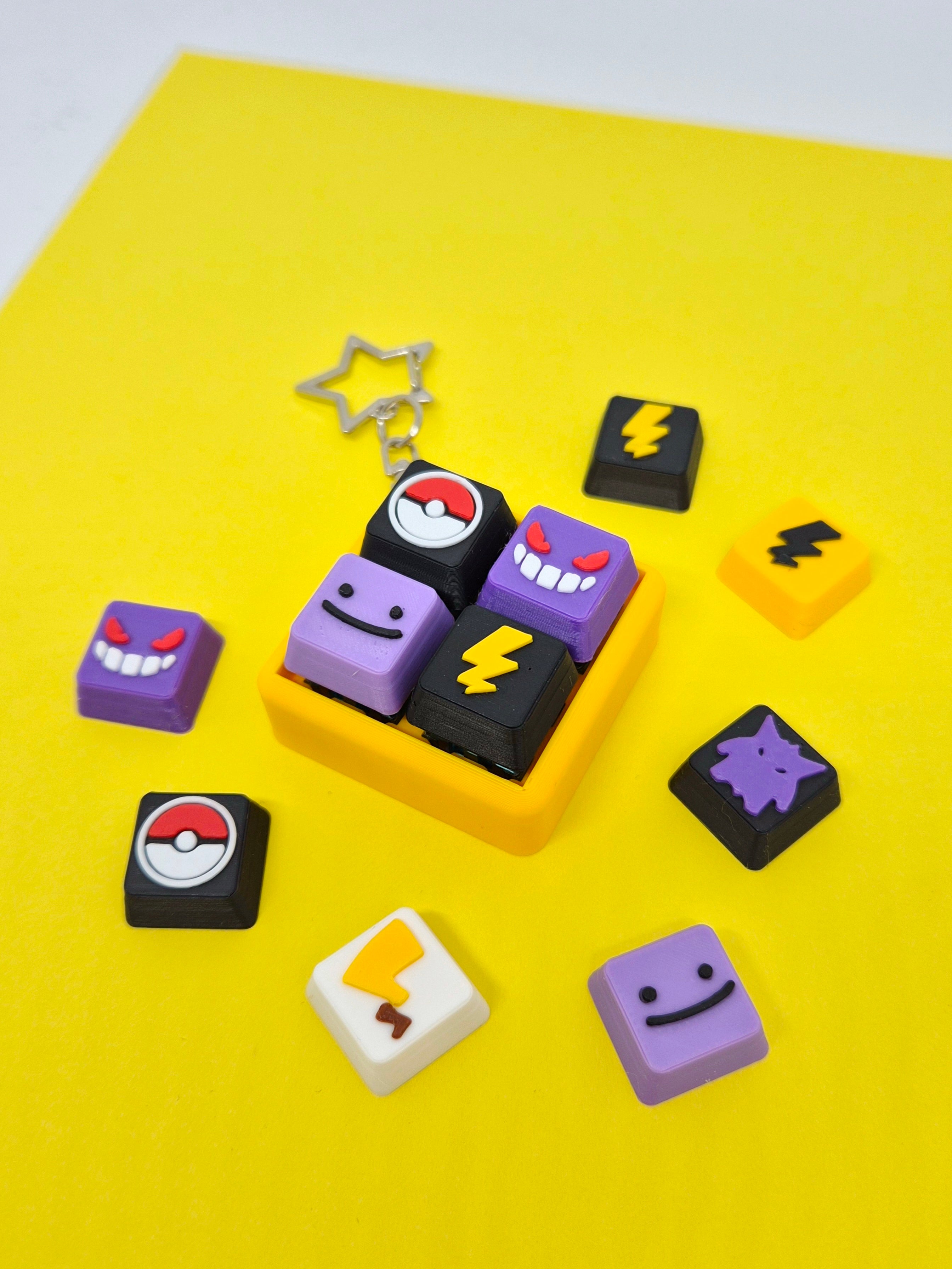Pokemon-themed Masa Crafts Studio fidget clicker keychain with colorful keycap featuring a Pikachu design and metal keyring.